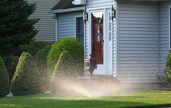 house with sprinkler running