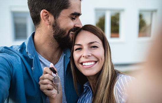 happy couple with house keys