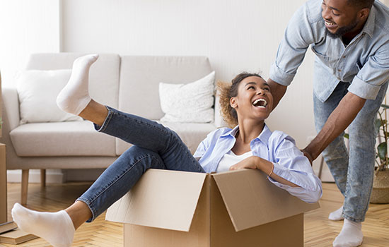 playful couple with cardboard boxes