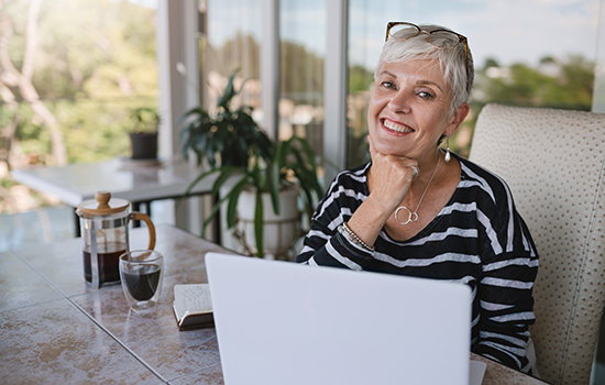 smiling senior woman with laptop