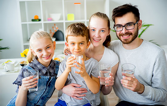 family of four drinking water together